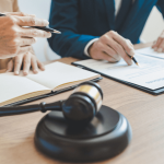 Client discussing how much does it cost for a debt lawyer during legal consultation with gavel and documents