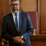 Experienced criminal defense attorney standing confidently in courtroom