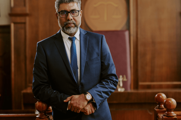 Experienced criminal defense attorney standing confidently in courtroom