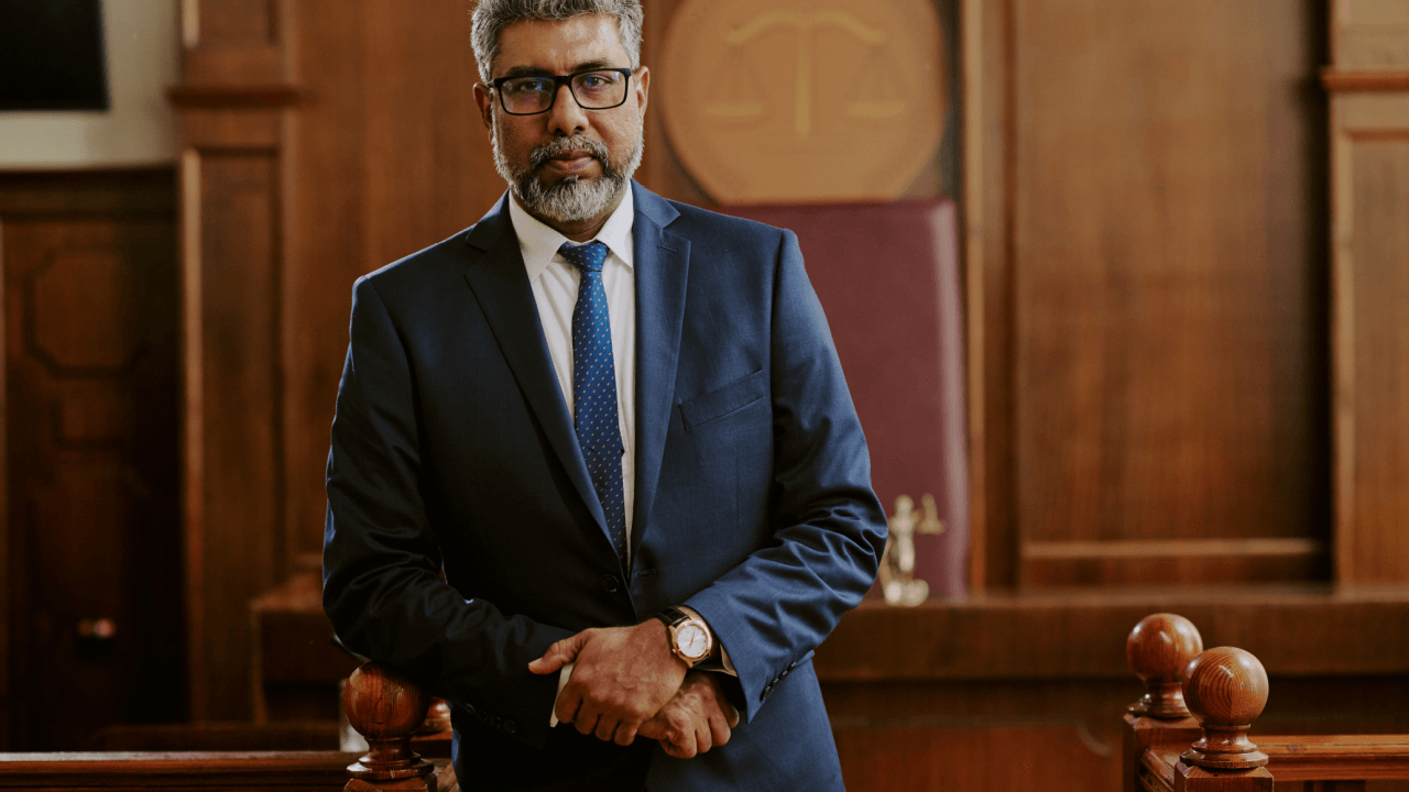 Experienced criminal defense attorney standing confidently in courtroom