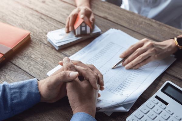 Person reviewing debt documents with calculator learning how long before a debt becomes uncollectible