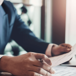 Professional reviewing debt collection lawsuit documents to understand how much debt collectors sue for