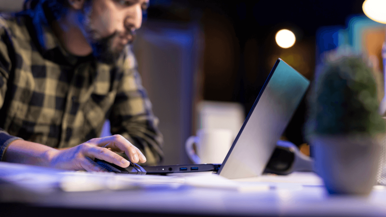 Is it better to settle a debt or go to court - Person researching whether it's better to settle a debt or go to court on laptop