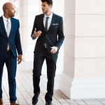 Two types of criminal lawyers discussing legal case in courthouse hallway