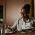 Professional criminal defense lawyer reviewing case files at desk - what do criminal defense lawyers do