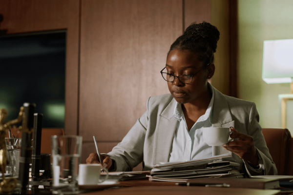 Professional criminal defense lawyer reviewing case files at desk - what do criminal defense lawyers do