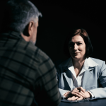 Client asking what questions to ask a criminal defense attorney during initial consultation meeting