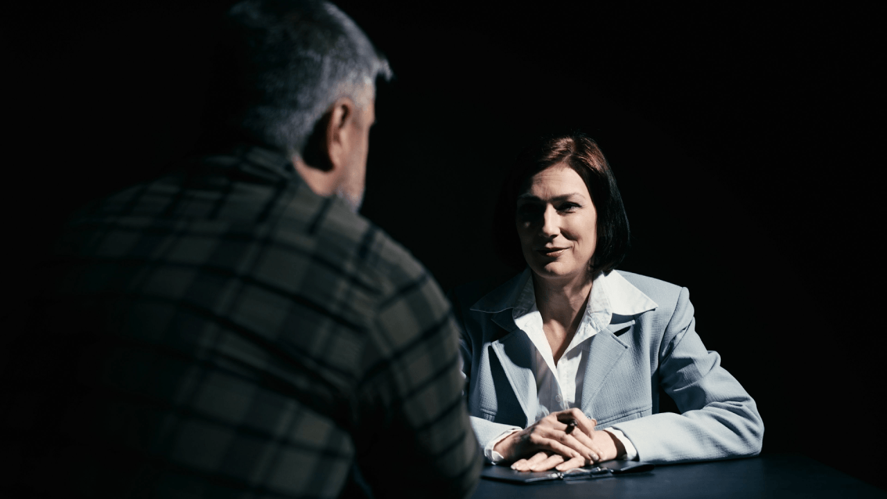 Client asking what questions to ask a criminal defense attorney during initial consultation meeting
