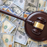 What is a reasonable amount to settle a debt - gavel on hundred dollar bills representing debt settlement negotiations