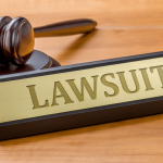 Employment lawsuit gavel and sign on wooden desk