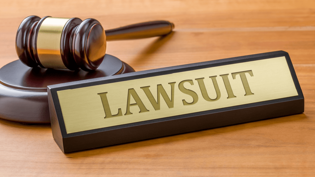 Employment lawsuit gavel and sign on wooden desk