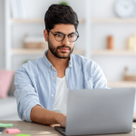 Professional researching names and terms for criminal defense roles on laptop