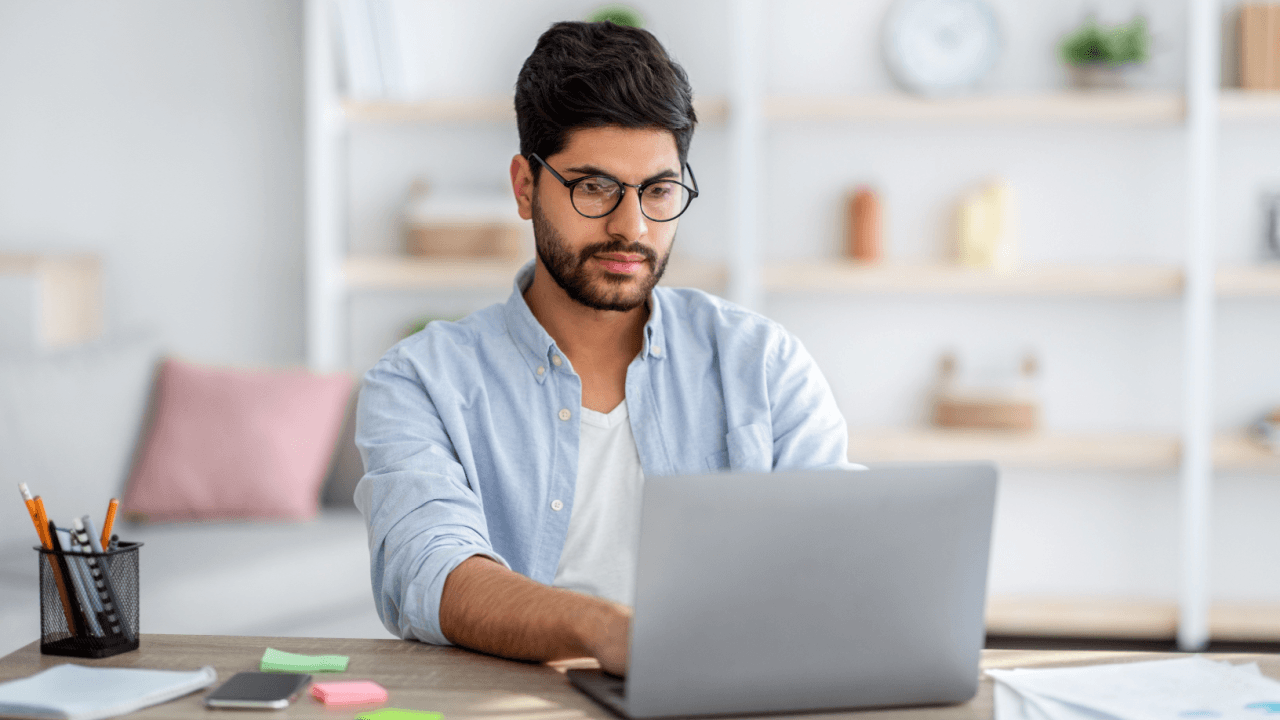 Professional researching names and terms for criminal defense roles on laptop