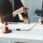 Legal professionals consulting over documents representing what do you call a lawyer that defends criminals
