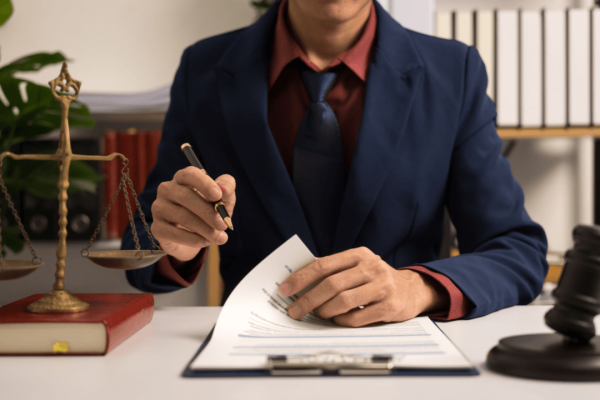 What does it take to be a criminal defense attorney reviewing legal documents at desk