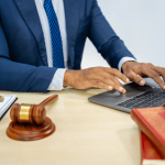 Why do criminal defense lawyers exist - attorney working on legal case at desk with gavel and scales of justice