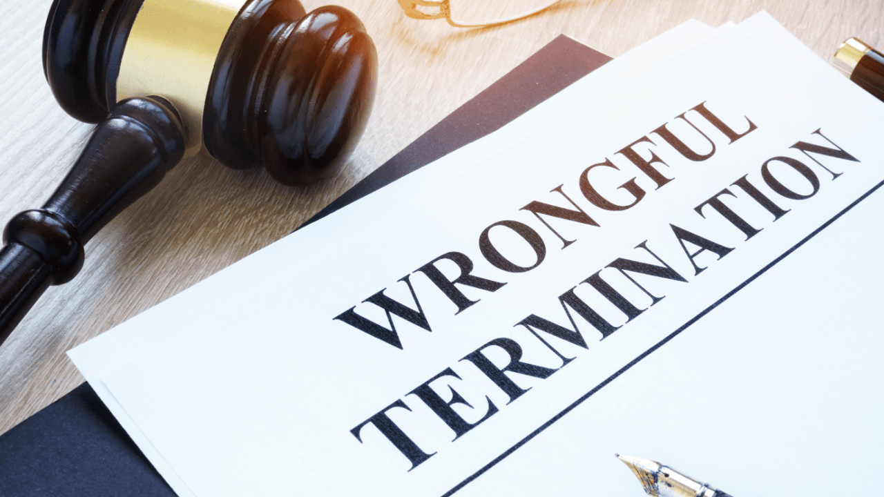 Wrongful termination legal document with gavel on desk