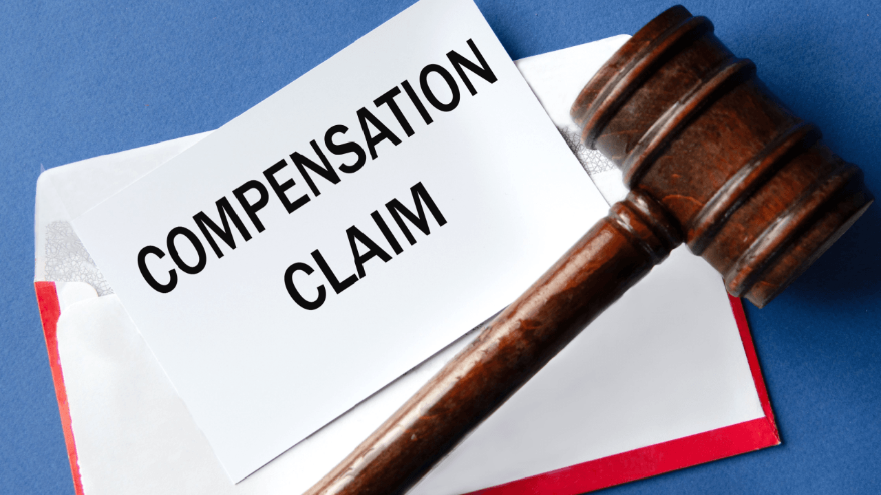 Wrongful termination compensation claim document with judge's gavel on blue background
