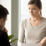 Woman presenting wrongful termination evidence to an attorney