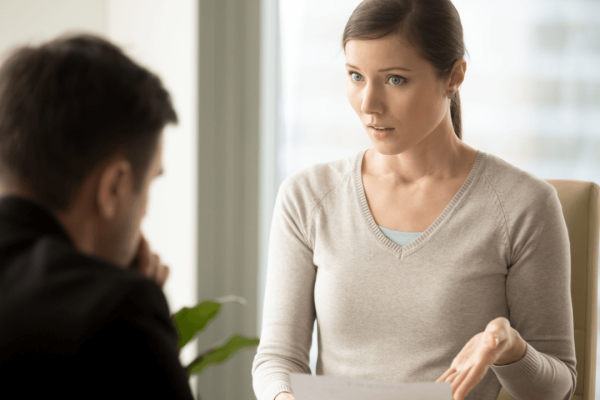 Woman presenting wrongful termination evidence to an attorney