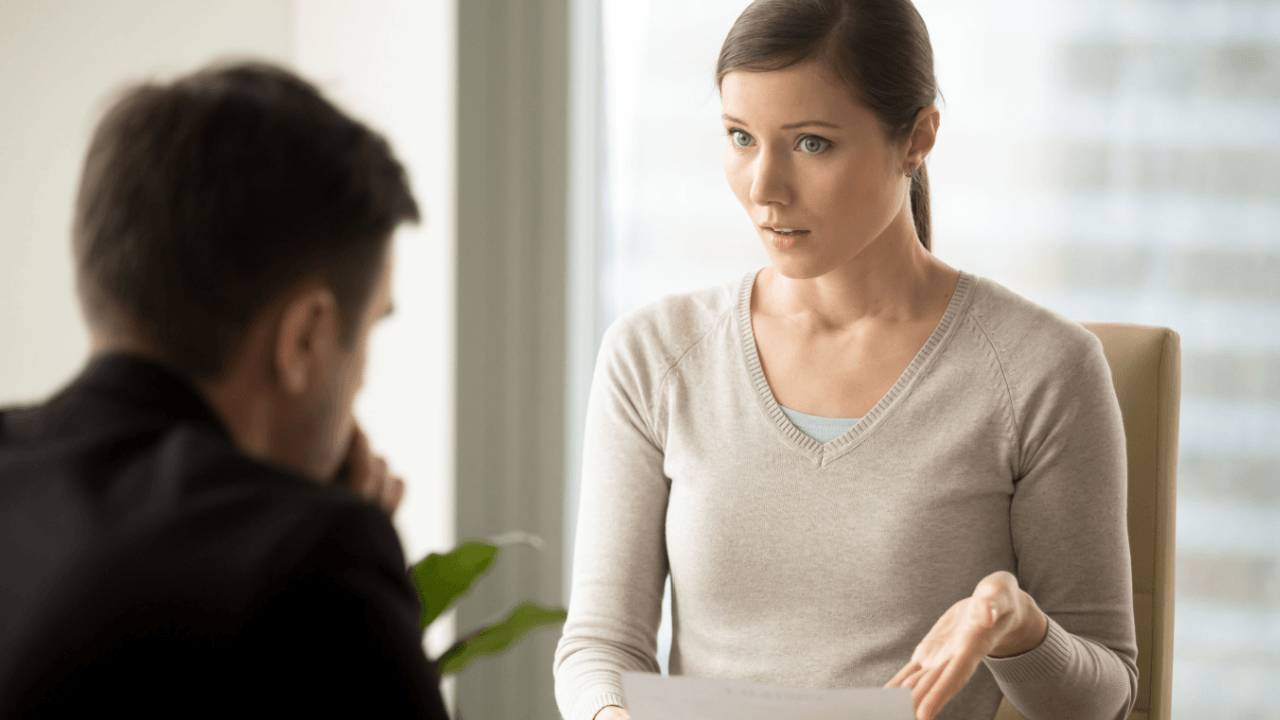 Woman presenting wrongful termination evidence to an attorney