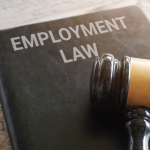 Employment law book and judge's gavel representing employee rights after termination