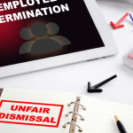 Fight unfair termination and unfair dismissal concept with tablet and notebook