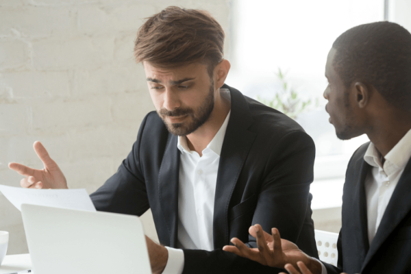Two professionals reviewing a wrongful termination case document at a desk