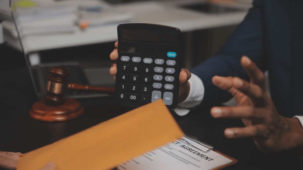 Attorney reviewing termination settlement calculations with client