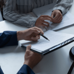 Attorney reviewing legal documents with client in disability discrimination by employers case