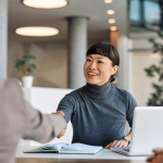 Attorney greeting client with handshake to discuss religious discrimination laws at work
