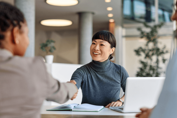 Attorney greeting client with handshake to discuss religious discrimination laws at work