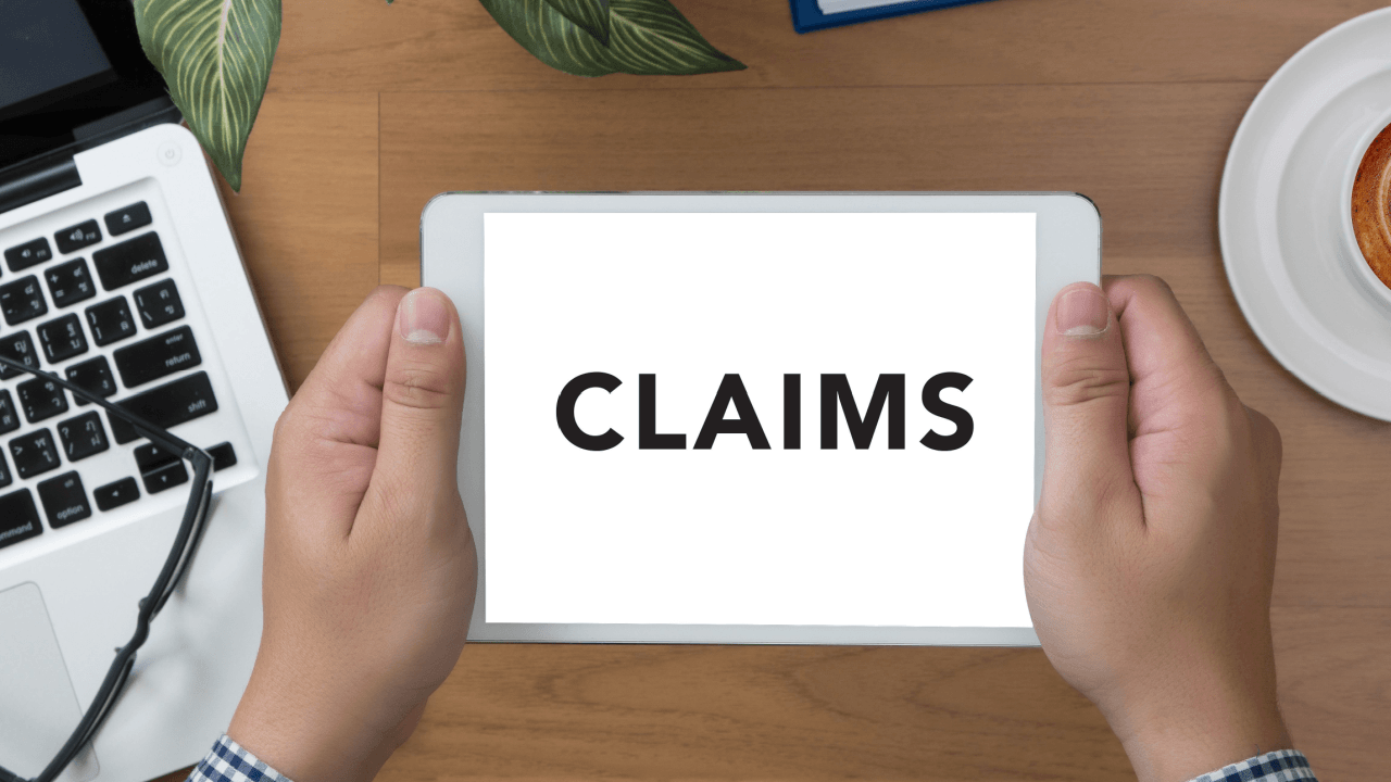 Person holding tablet displaying claims screen representing the wrongful termination claims process