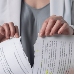 Woman tearing a legal contract in half
