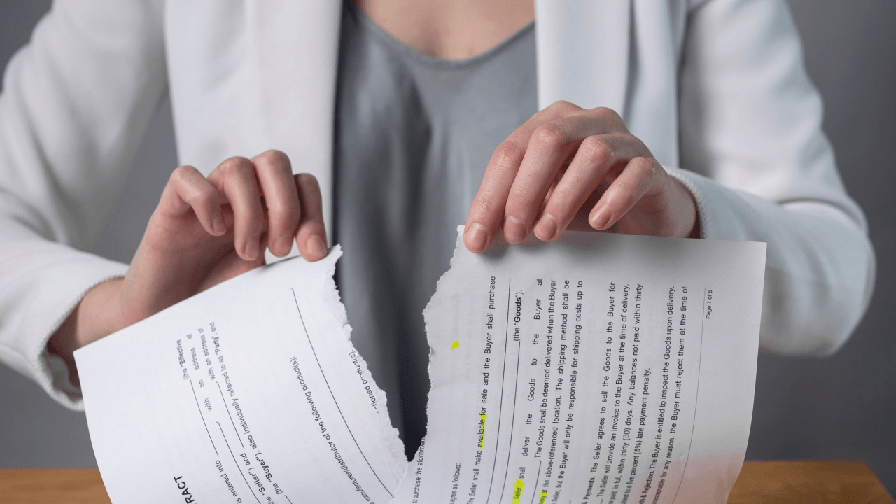 Woman tearing a legal contract in half