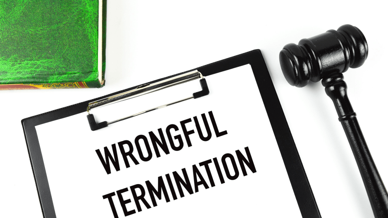 Wrongful termination clipboard with gavel and law book