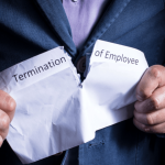 Man tearing termination of employment document