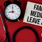Family Medical Leave Act sign with clock and stethoscope showing can you be fired while on FMLA leave