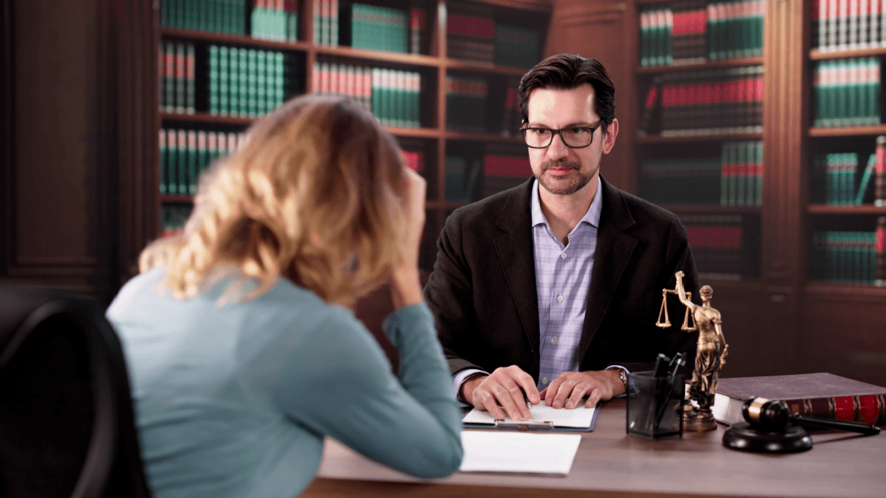Attorney listening to distressed client describe workplace retaliation warning signs in law office