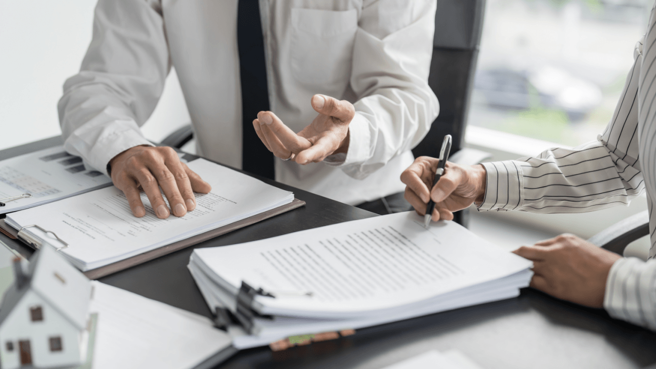 Attorney and client reviewing documents related to employee misclassification and overtime pay claim
