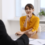 Woman consulting an attorney about FMLA retaliation by employers in a law office setting