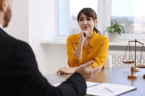 Woman consulting an attorney about FMLA retaliation by employers in a law office setting
