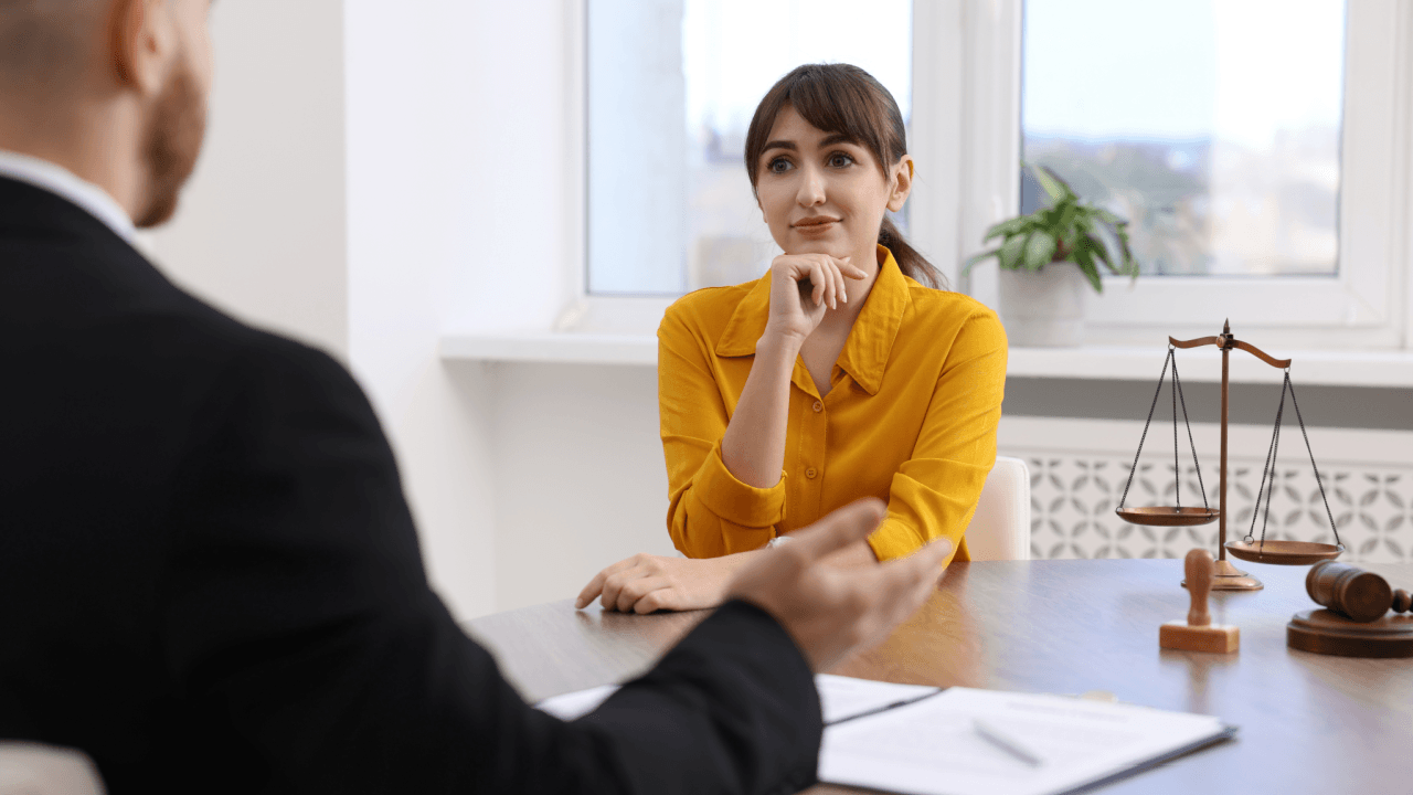 Woman consulting an attorney about FMLA retaliation by employers in a law office setting