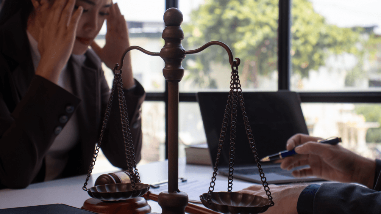Distressed employee meeting with attorney about retaliation after filing an EEOC complaint