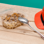 Construction worker meal and hard hat on job site representing meal and rest break labor violations
