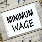 Notebook displaying minimum wage text representing minimum wage violation claims workers can file