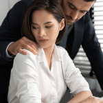 Woman experiencing sexual harassment at work rights violation by male coworker in office setting