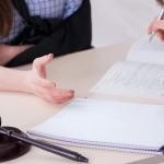 Slip and fall lawyer meeting with an injured client to review accident claim documents
