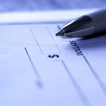 Blank check with pen representing what to do about missing paychecks and wage theft claims
