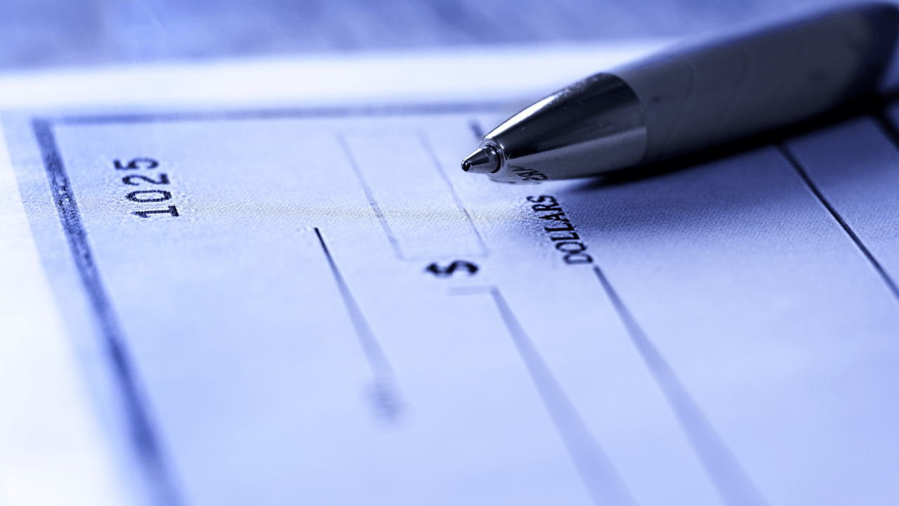 Blank check with pen representing what to do about missing paychecks and wage theft claims